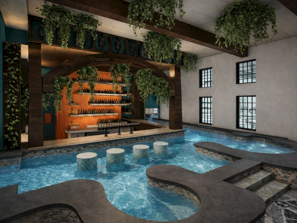 A luxurious indoor pool area with a flowing water feature, stepping stones, greenery, and a cozy bar/terrace under hanging plants. End.