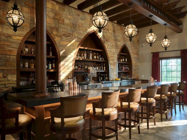 A cozy bar with arched shelves, warm lighting, and leather stools lining a wooden counter, perfect for relaxed drinks and conversations.