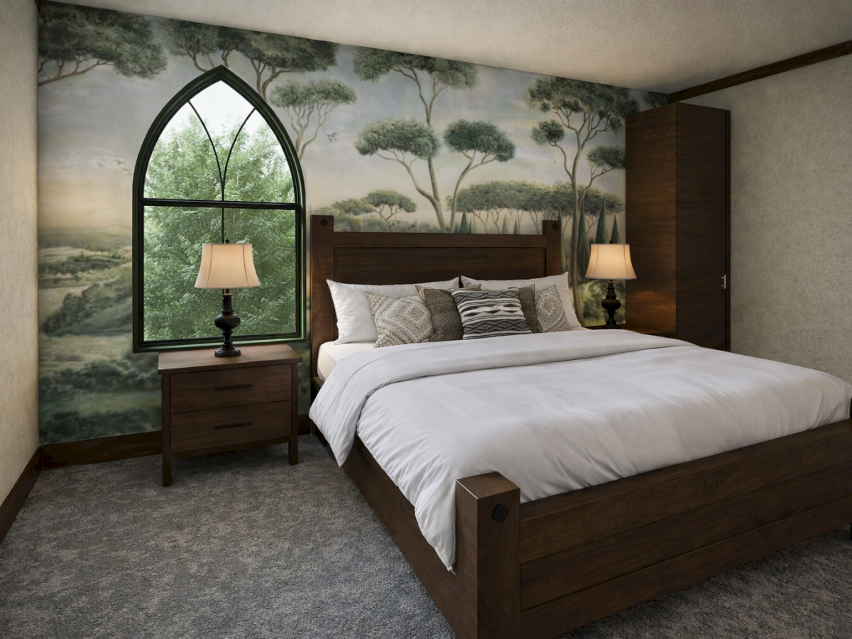 A large wooden bed with white linens and pillows, two matching nightstands with lamps, a mural wall, carpet, and a tall windowed arch.