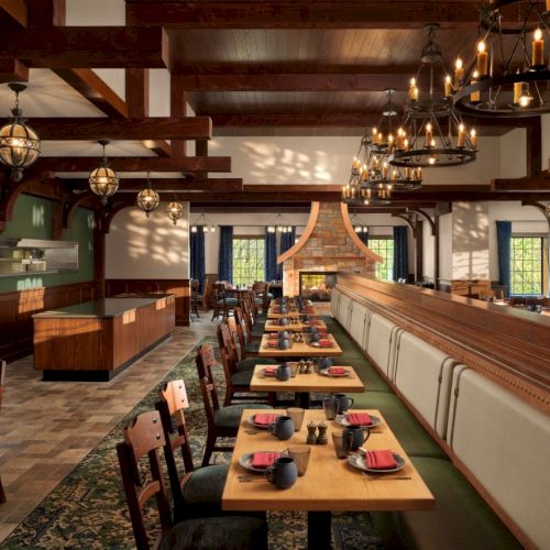 A cozy, warmly lit restaurant or caf&eacute; with wooden tables, lattice windows, and shelves; patrons dine amid rustic decor and warm ambience.
