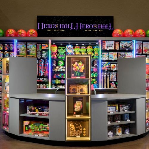A cheerful arcade clothing store or toy shop with bright neon shelves, a curved central display, and colorful boxed products, creating a playful showroom vibe.