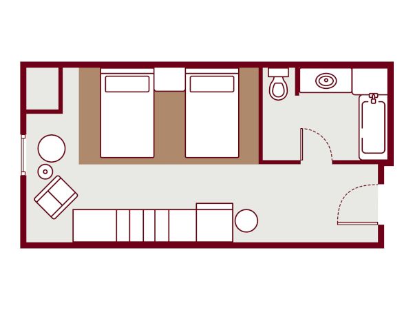A small apartment floor plan with two beds in the main room, a seating area, a kitchen/sofa along one wall, and a separate bathroom with a tub at the far end. There&rsquo;s a door entry on the right and a hallway leading to the bedrooms.