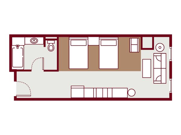 A small apartment floor plan with a bathroom on the left, a row of beds in the middle, a living area at the right, and a staircase/entry along the bottom, all in a single rectangular layout.