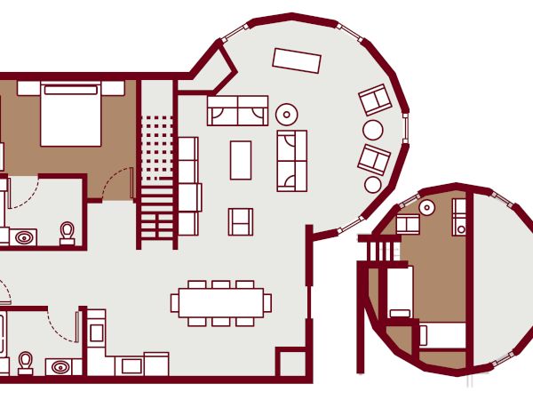 A floor plan showing a two-story layout: left side has bedrooms, bathrooms, and a kitchen; central open living/dining area; right circular wing with additional rooms.