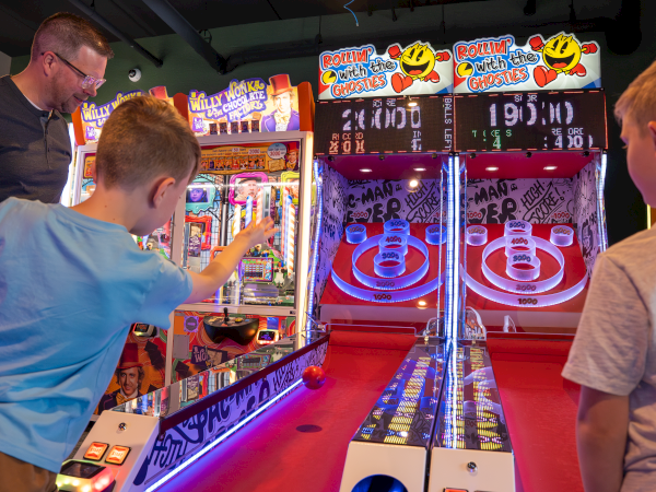 People play a spooky arcade game, &ldquo;Rollin&rsquo; with the Ghosties,&rdquo; aiming shots at the glowing score rings.