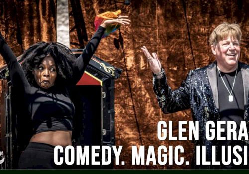 A magician performer poses onstage with assistants, under the text &ldquo;Comedy. Magic. Illusion&rdquo; and &ldquo;Glen Gerard.&rdquo;